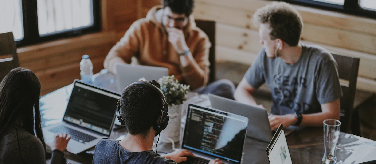 A team working together on laptops around a table